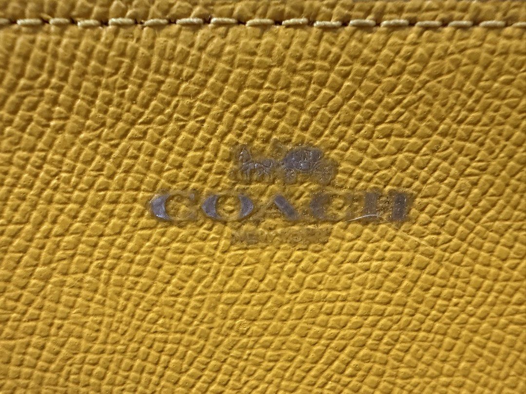 Authentic Coach Wristlet (Category: Luxury Bags & Wallets) located in Manila. Submitted by princesshiz (Listing ID 1454368345, Image 2). Description: - Authentic Coach yellow leather wristlet - Features iconic Coach logo in front - Interior branded tag for authenticity - Comes with original Coach box .