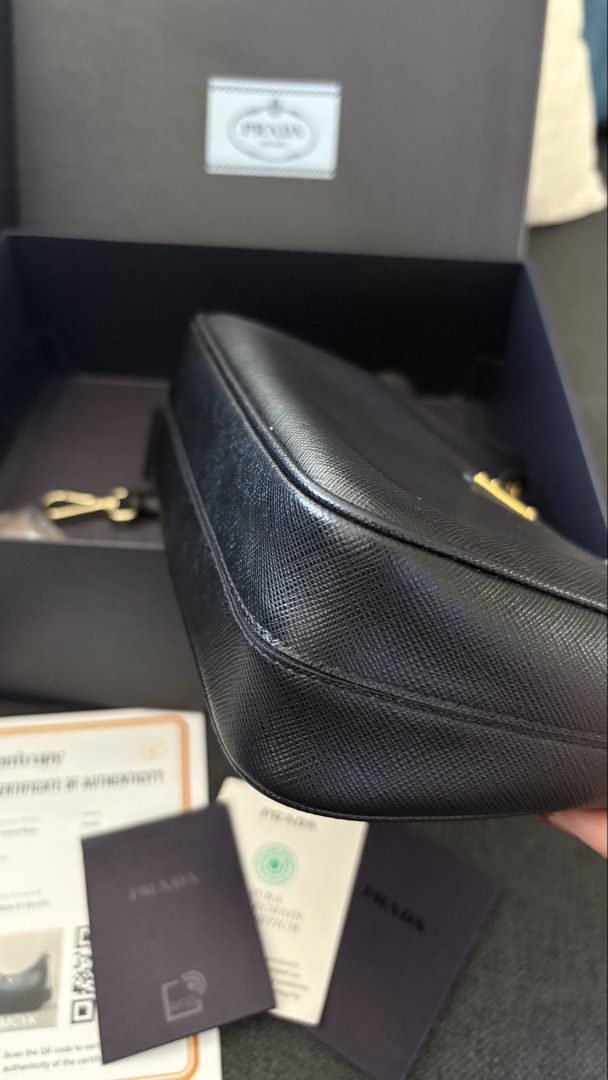 Authentic Prada Re-Edition 2005 saffiano leather (Category: Luxury Bags & Wallets) located in Zamboanga. Submitted by sanyunngg26 (Listing ID 1454456047, Image 3). Description: Authentic Prada Re-Edition 2005 shoulder bag in saffiano leather. •w/ dustbag, box & authenticity cards. •Entrupy cert is also provided •Almost brandnew (no flaws at all) RFS: Doesn't fit my mommy lifestyle anymore 🥲 lol.