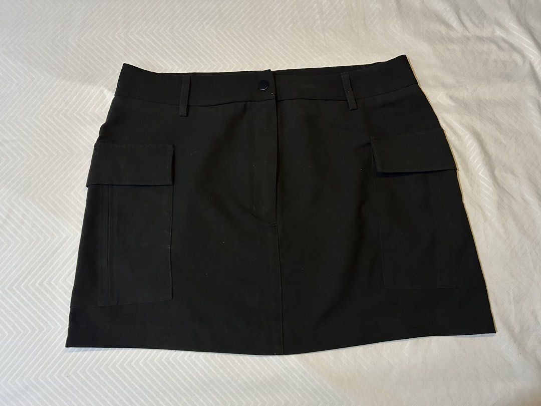 Black Cargo Mini Skirt (Category: Skirts) located in Manila. Submitted by fromrie (Listing ID 1454468335, Image 1). Description: - Black cargo mini skirt - Two front pockets - Two side flap pockets - Button and zip closure - Belt loops on waistband - Ideal for casual wear - Measurements available in photos fits 32-33 never worn.
