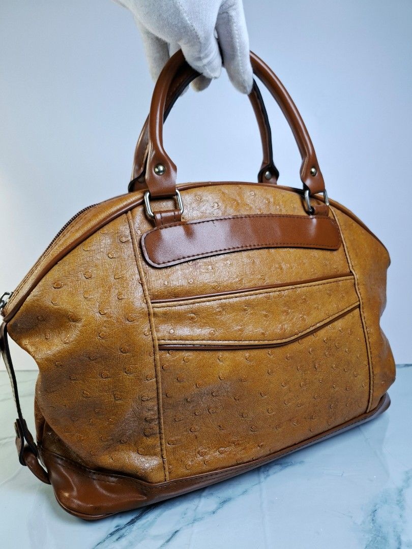 Brown Ostrich Embossed Leather Handbag (Category: Tote Bags) located in Pasay City. Submitted by onick_79 (Listing ID 1454439596, Image 2). Description: -Dimensions L 13.5 x H 10.5 x W 5.5 Inches - Rich brown leather handbag - Unique ostrich embossed texture - Sturdy top handles for comfortable carrying - Secure zippered closure - Versatile and classic style - Ideal for daily essentials.