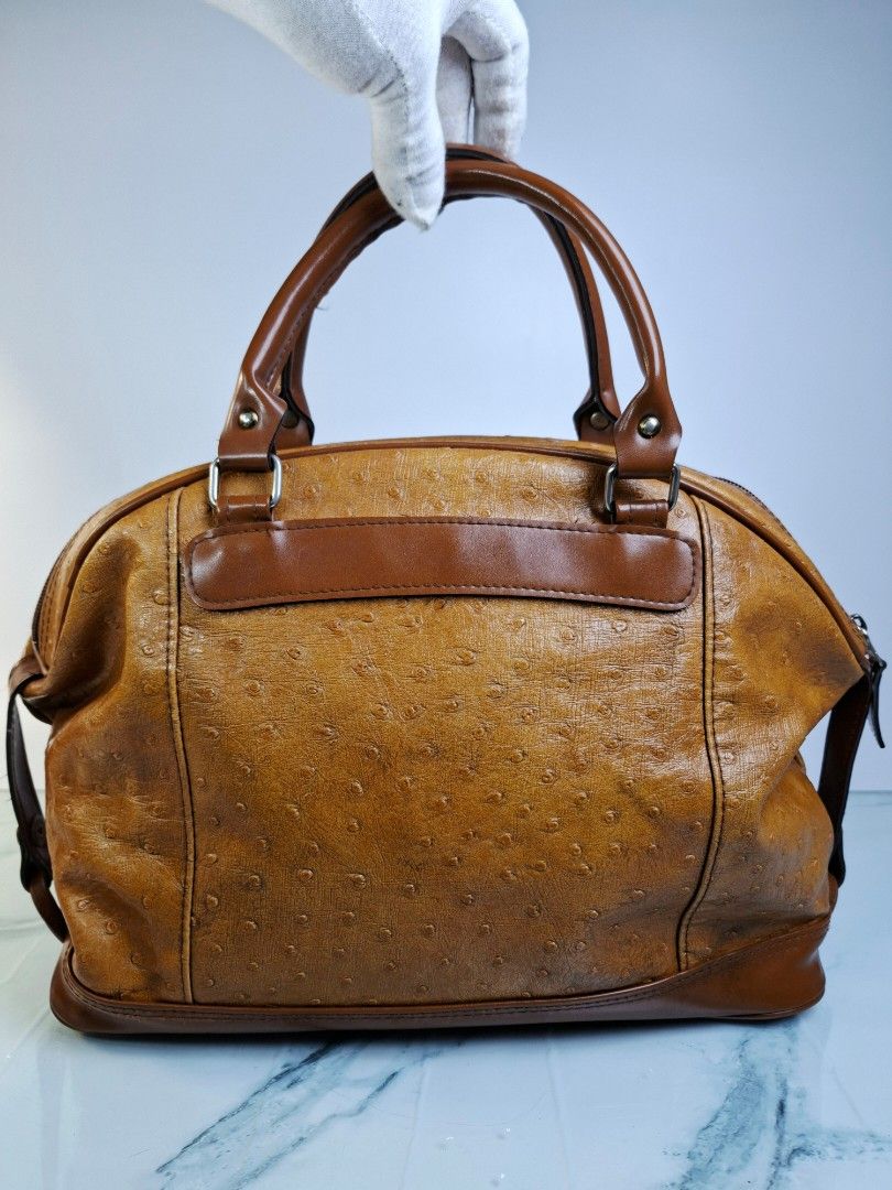 Brown Ostrich Embossed Leather Handbag (Category: Tote Bags) located in Pasay City. Submitted by onick_79 (Listing ID 1454439596, Image 3). Description: -Dimensions L 13.5 x H 10.5 x W 5.5 Inches - Rich brown leather handbag - Unique ostrich embossed texture - Sturdy top handles for comfortable carrying - Secure zippered closure - Versatile and classic style - Ideal for daily essentials.