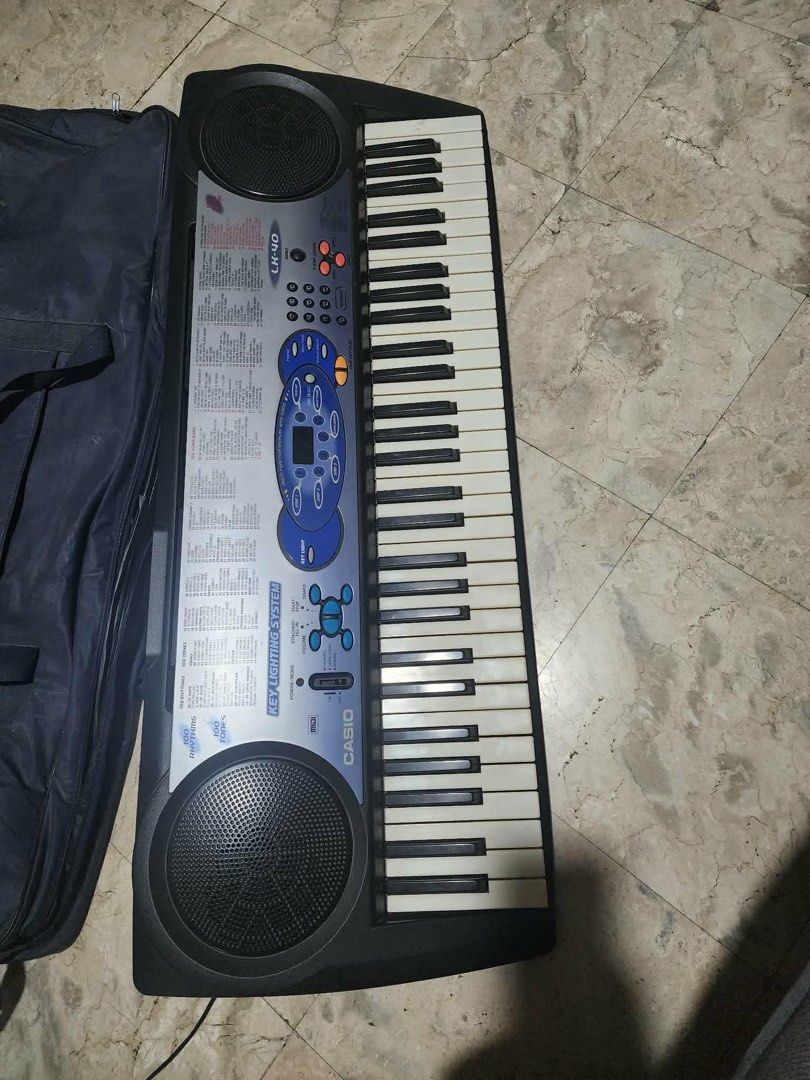 Casio LK-40 Keyboard with Carry Bag and Stand (Category: Computer Keyboard) located in Manila. Submitted by kathy_gonzales (Listing ID 1454483589, Image 3). Description: - Casio LK-40 Keyboard - Functional Key Lighting System (Great for Learning!) - Includes Casio Carry Bag - 100 Song Bank Tunes - Built-in Speakers - Ideal for Beginners Wala lang dyan yung picture ng stand pero may stand po yan. Thanks!.