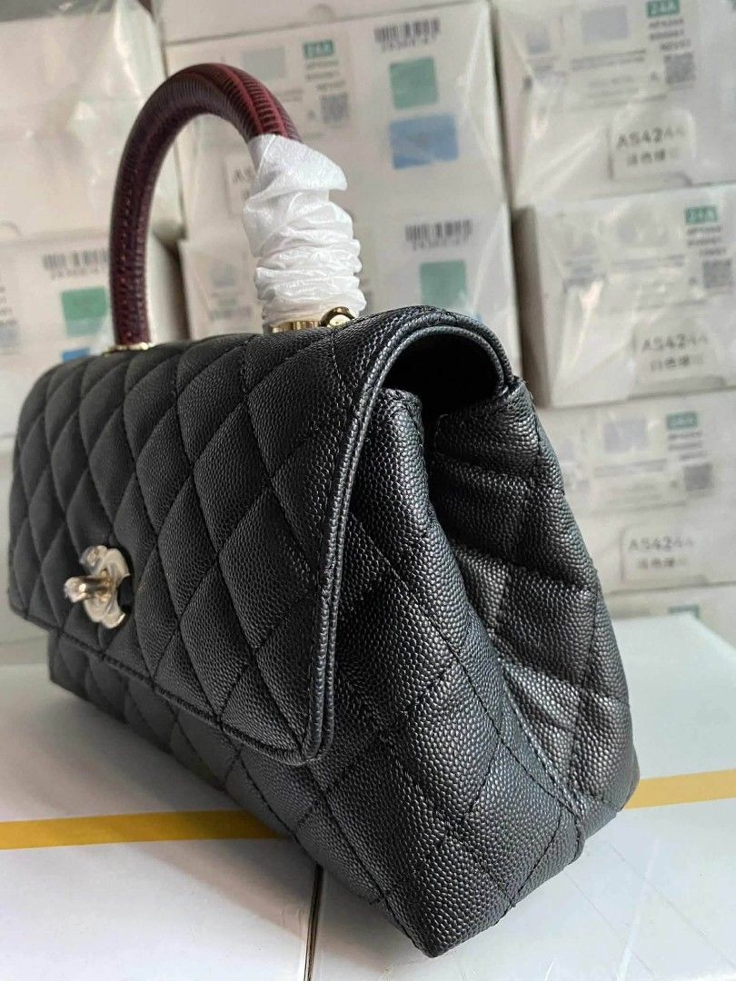 Chanel Coco Handle Bag in black caviar leather (Category: Luxury Bags & Wallets) located in Santa Cruz. Submitted by Authentic_Branded_Bags (Listing ID 1454513861, Image 3). Description: Chanel Coco Handle Bag in black caviar leather with a distinctive dark red embossed top handle. Design: Features iconic diamond quilting and a classic interlocking CC clasp. Handle: Includes a structured top handle, often reinforced or embossed to resemble exotic