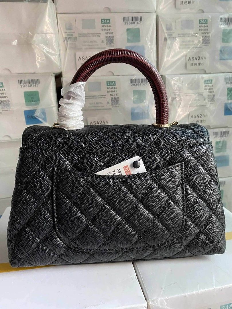 Chanel Coco Handle Bag in black caviar leather (Category: Luxury Bags & Wallets) located in Santa Cruz. Submitted by Authentic_Branded_Bags (Listing ID 1454513861, Image 2). Description: Chanel Coco Handle Bag in black caviar leather with a distinctive dark red embossed top handle. Design: Features iconic diamond quilting and a classic interlocking CC clasp. Handle: Includes a structured top handle, often reinforced or embossed to resemble exotic