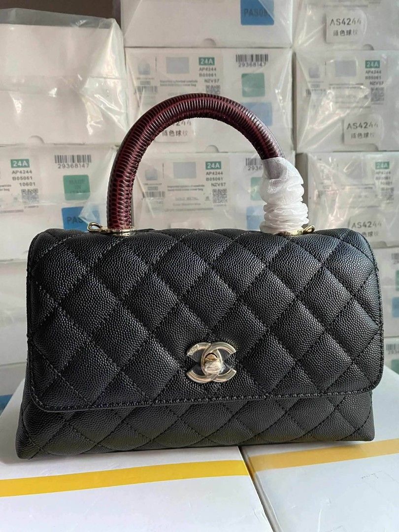 Chanel Coco Handle Bag in black caviar leather (Category: Luxury Bags & Wallets) located in Santa Cruz. Submitted by Authentic_Branded_Bags (Listing ID 1454513861, Image 1). Description: Chanel Coco Handle Bag in black caviar leather with a distinctive dark red embossed top handle. Design: Features iconic diamond quilting and a classic interlocking CC clasp. Handle: Includes a structured top handle, often reinforced or embossed to resemble exotic
