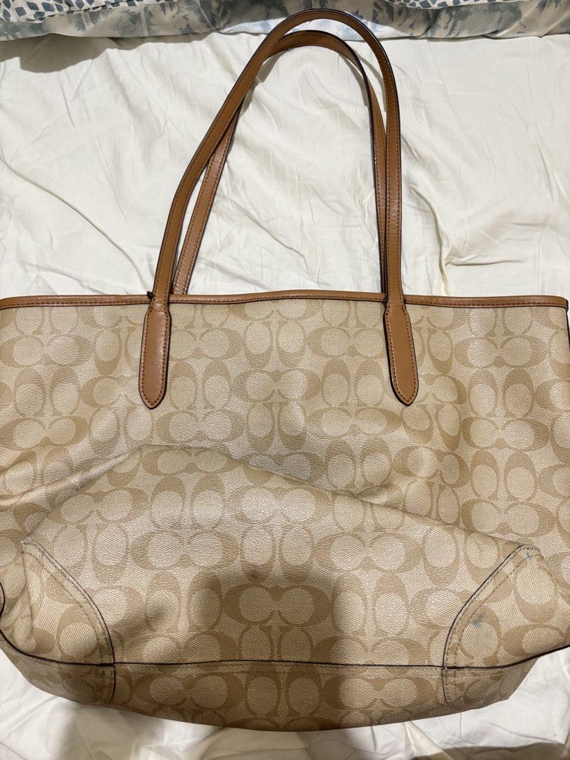 Coach City Tote Bag (Category: Luxury Bags & Wallets) located in Davao. Submitted by faerygrunge (Listing ID 1454539622, Image 3). Description: - Please manage your expectations and refer to the photos before purchasing. - Authentic - Minor stains - Strap has visible signs of wear, with some fraying/loose stitching near the attachment area - Interior has visible leather cracking - Ships nationwide - Can do meet up (Davao City only, downtown area 