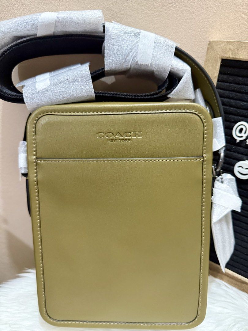 Coach Green Sullivan Small Crossbody Bag (Category: Luxury Bags & Wallets) located in Las Pinas. Submitted by anasonlineshophtplaspinas (Listing ID 1454458662, Image 2). Description: Coach Green Sullivan Small Crossbody Bag Material: Smooth calfskin leather with gunmetal-tone hardware accents.Exterior: Clean rectangular silhouette featuring a debossed “COACH NEW YORK” logo on the front panel and a spacious front open slip pocket.Strap: Features a