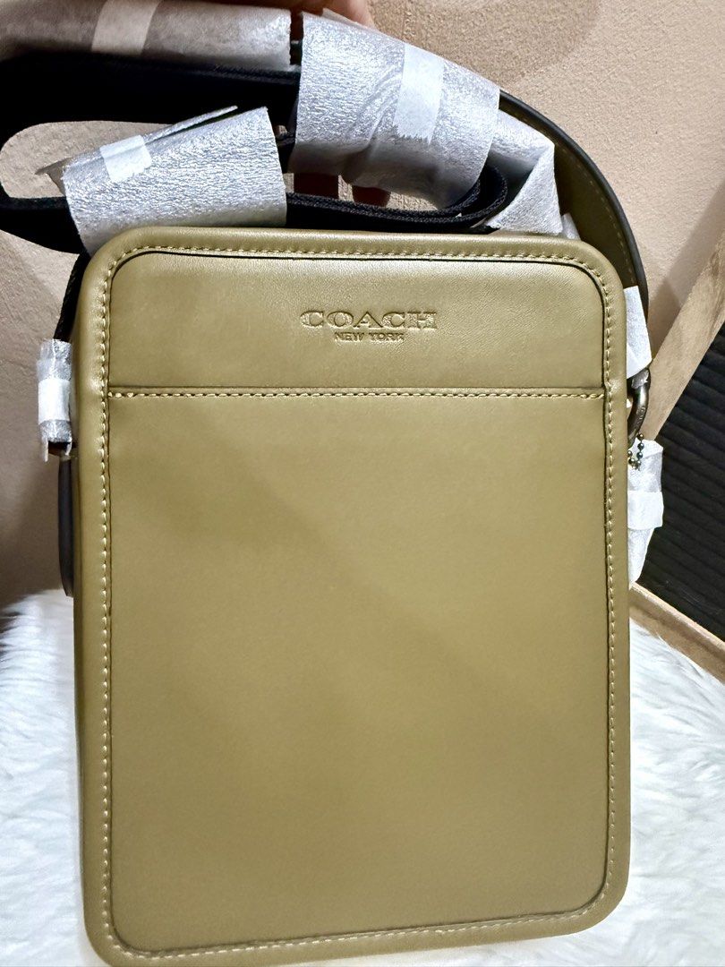 Coach Green Sullivan Small Crossbody Bag (Category: Luxury Bags & Wallets) located in Las Pinas. Submitted by anasonlineshophtplaspinas (Listing ID 1454458662, Image 3). Description: Coach Green Sullivan Small Crossbody Bag Material: Smooth calfskin leather with gunmetal-tone hardware accents.Exterior: Clean rectangular silhouette featuring a debossed “COACH NEW YORK” logo on the front panel and a spacious front open slip pocket.Strap: Features a