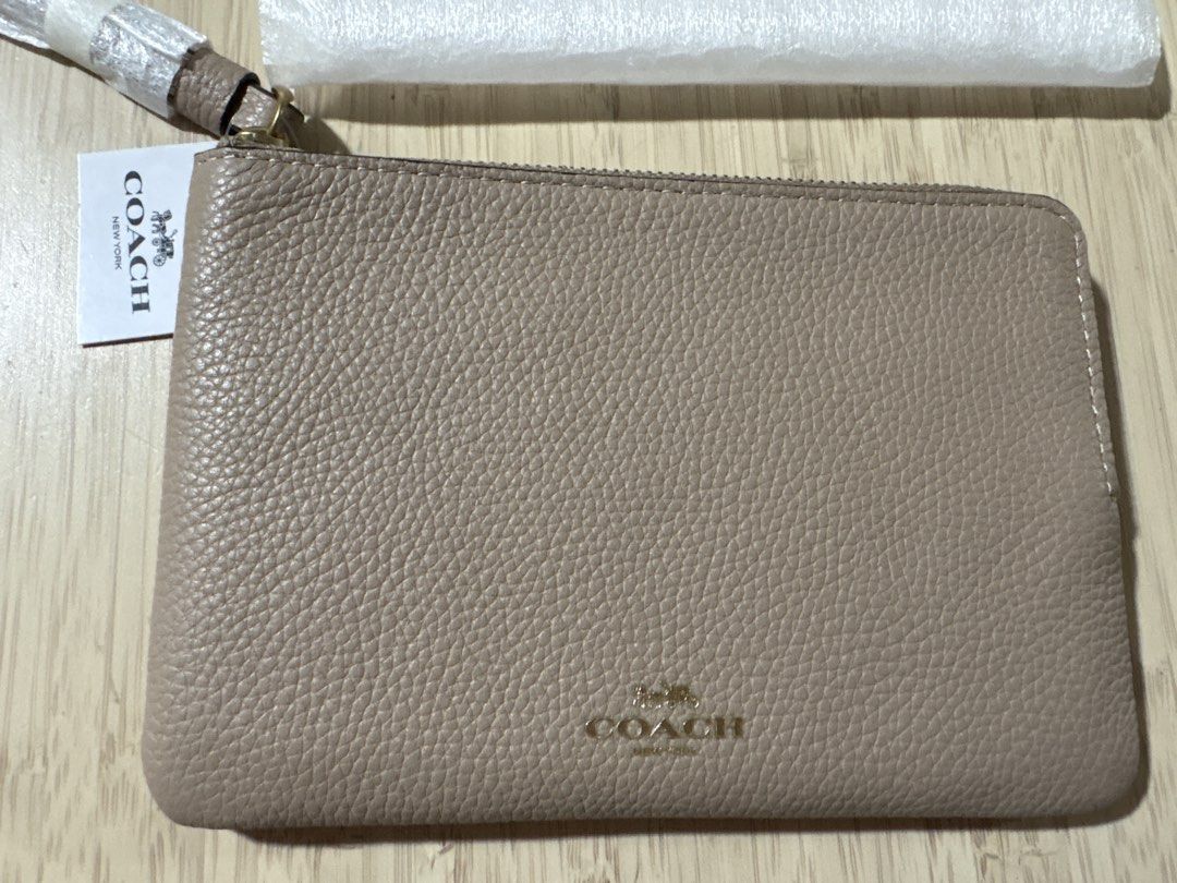 Coach Leather Wristlet Pouch Taupe (Category: Purses & Pouches) located in Pasig City. Submitted by teep_mnl (Listing ID 1454467020, Image 3). Description: Coach wrislet Corner Zip in taupe Wristlet Not sure What The leather is because this was gifted. It’s gold hardware but the coach logo is not metal. Like the same as my outlet bought wristlet. Didn’t come With a box Just The tag on. Ample interior space for essentials for a regular size iphone