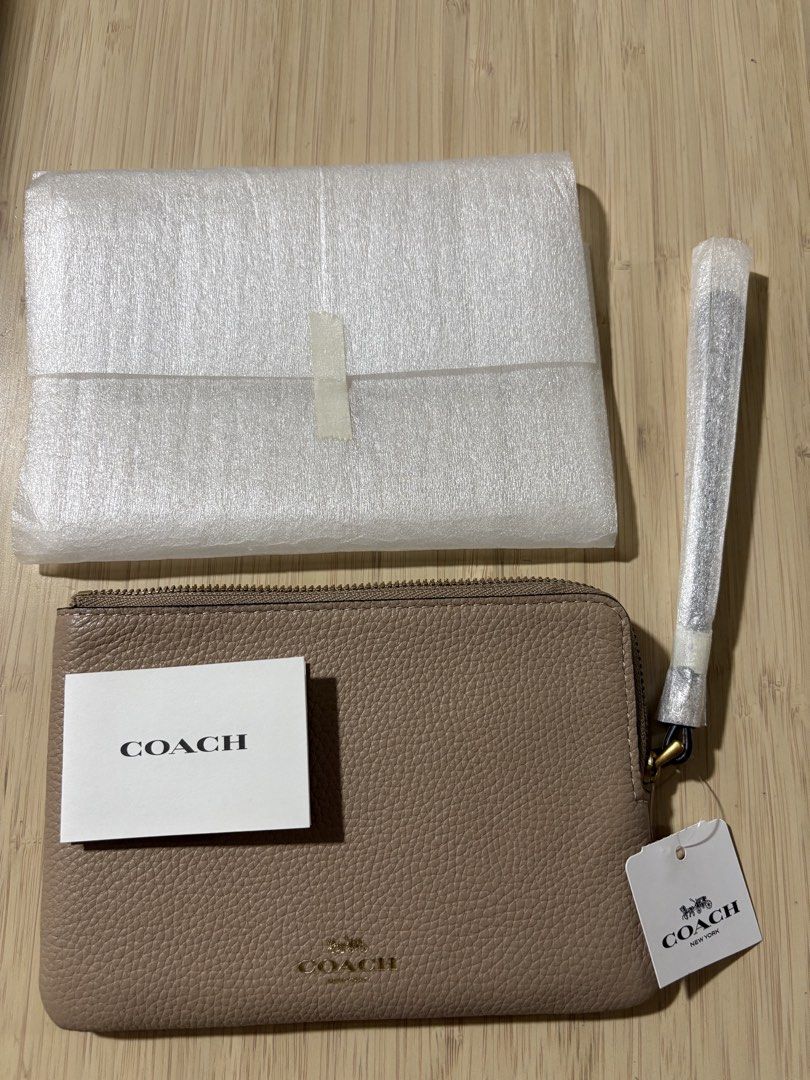 Coach Leather Wristlet Pouch Taupe (Category: Purses & Pouches) located in Pasig City. Submitted by teep_mnl (Listing ID 1454467020, Image 1). Description: Coach wrislet Corner Zip in taupe Wristlet Not sure What The leather is because this was gifted. It’s gold hardware but the coach logo is not metal. Like the same as my outlet bought wristlet. Didn’t come With a box Just The tag on. Ample interior space for essentials for a regular size iphone