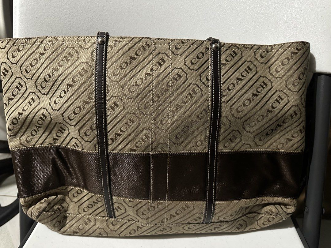 Coach Monogram Canvas & Leather Tote Bag (Category: Shoulder Bags) located in Manila. Submitted by chinitangtisay (Listing ID 1454418723, Image 2). Description: - Classic Coach tote bag - Beige canvas with all-over 'COACH' logo print - Dark brown leather accents and straps - Secure zipper closure - Spacious interior with pockets - Ideal for daily use and practicality.