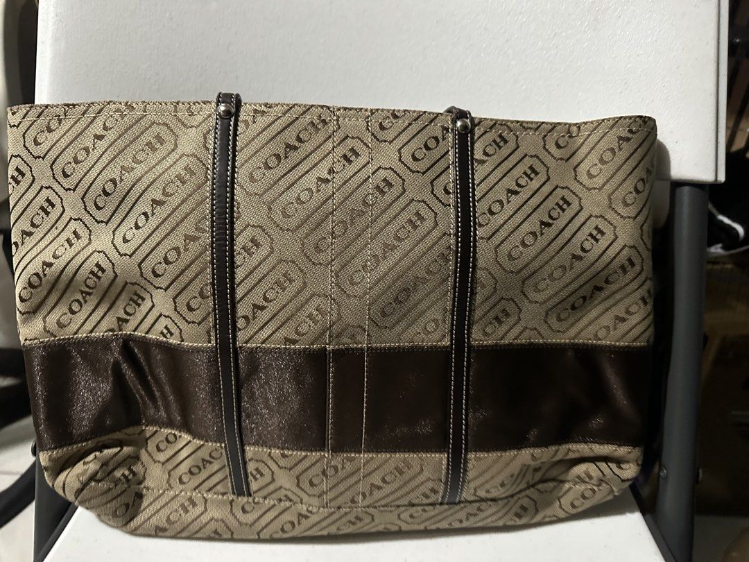 Coach Monogram Canvas & Leather Tote Bag (Category: Shoulder Bags) located in Manila. Submitted by chinitangtisay (Listing ID 1454418723, Image 1). Description: - Classic Coach tote bag - Beige canvas with all-over 'COACH' logo print - Dark brown leather accents and straps - Secure zipper closure - Spacious interior with pockets - Ideal for daily use and practicality.