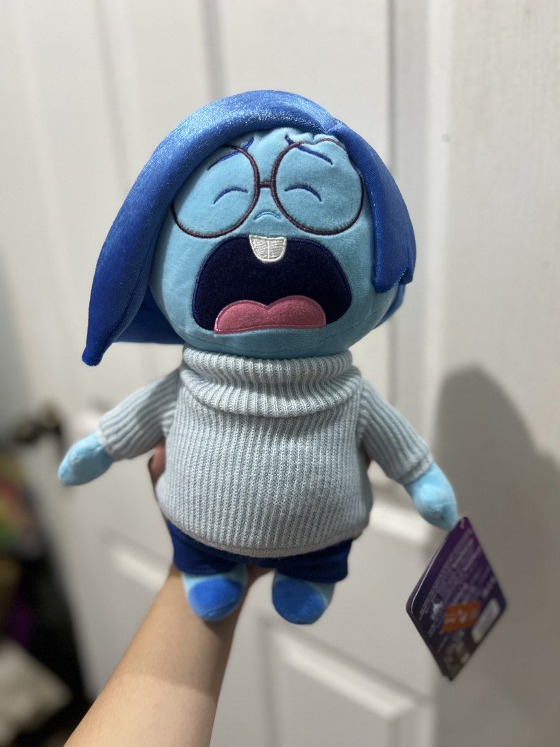 Disney Inside Out Sadness Plush Toy (Category: Plushies & Soft Toys) located in Cavite. Submitted by prelovedbyleendc (Listing ID 1454441356, Image 1). Description: - Sadness plush toy from Disney's Inside Out - Features her iconic sweater and jeans - Original tag still attached - Perfect for fans, collectors, or as a cuddle buddy - Bought in Hongkong .