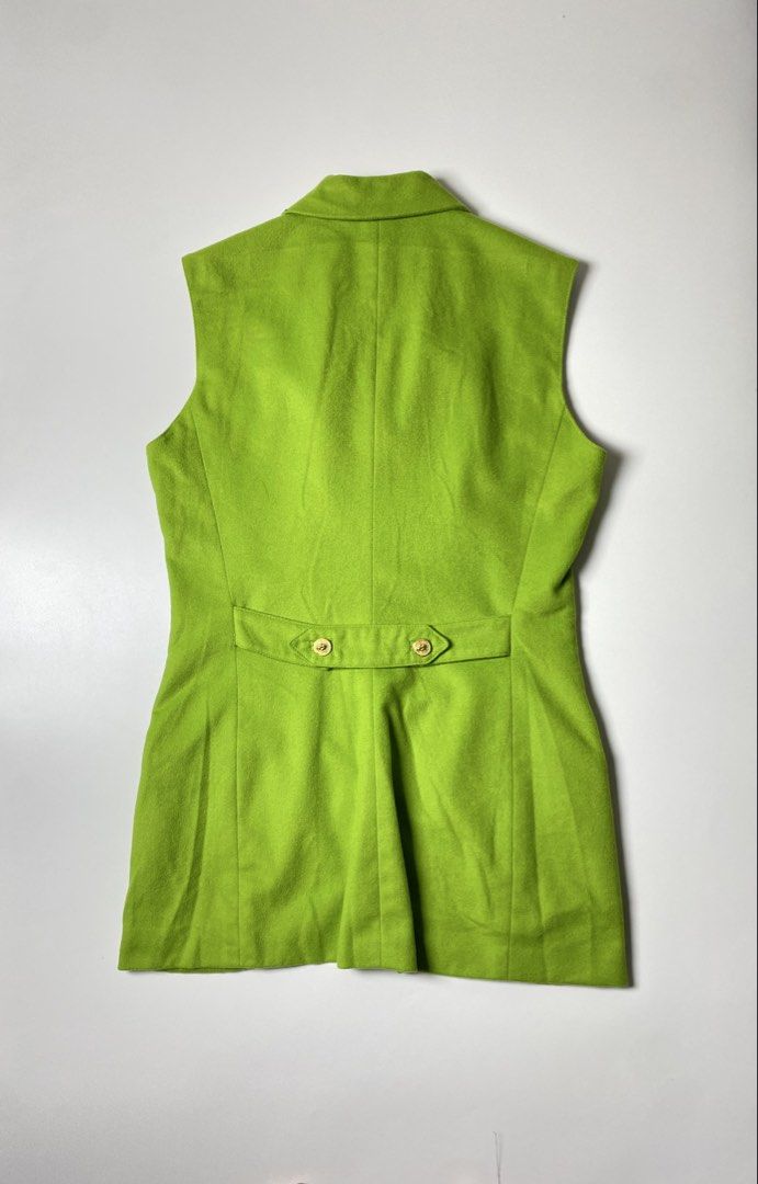 GIANNI VERSACE VERSUS WOOL WAISTCOAT (Category: Luxury Apparel) located in Balanga. Submitted by faded_garmz (Listing ID 1454372042, Image 2). Description: GIANNI VERSACE VERSUS WOOL WAISTCOAT This vintage Versus Gianni Versace waistcoat is crafted from a vibrant lime green wool fabric, structured with princess seams to create a highly tailored, longline silhouette. It features a sophisticated notched collar, a classic lapel, two horizontal welt 