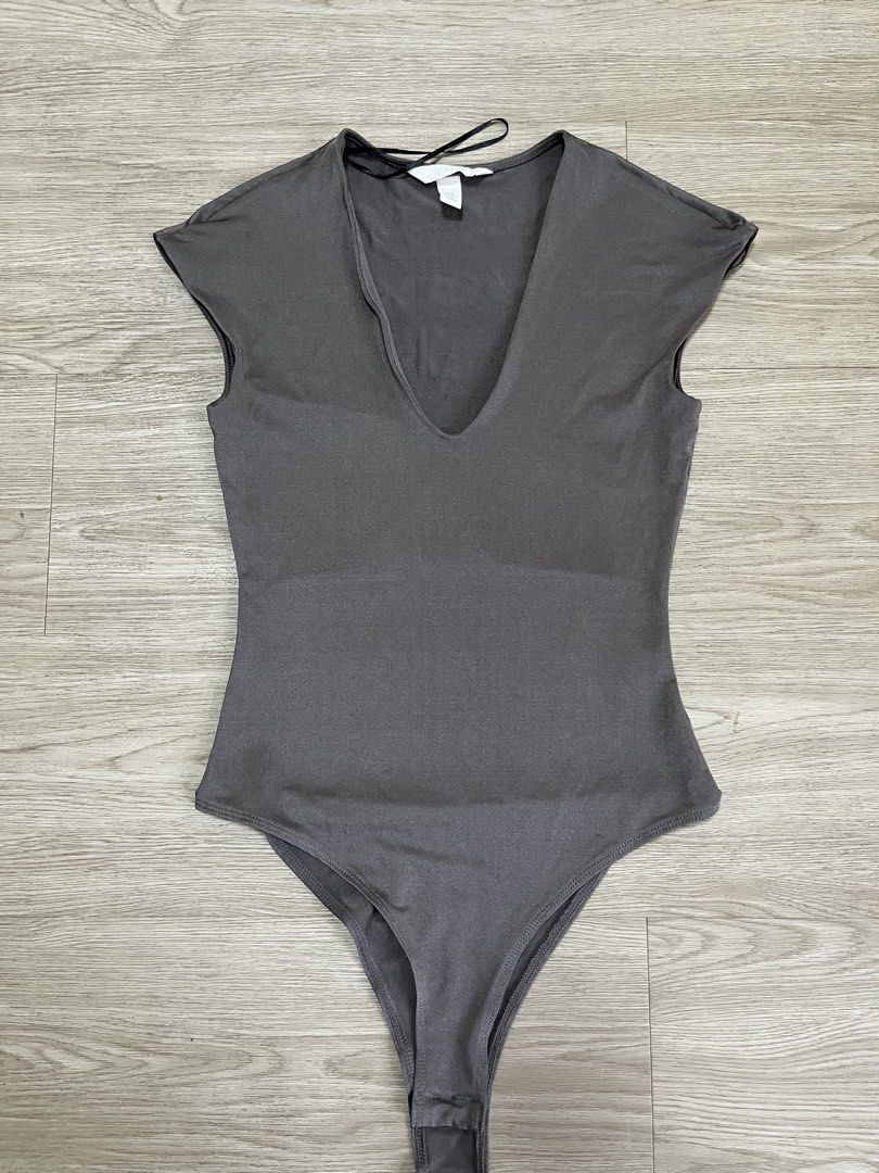 H&M Grey V-Neck Cap Sleeve Bodysuit (Category: Others Tops) located in Taytay. Submitted by j1123 (Listing ID 1454409105, Image 2). Description: - Grey H&M bodysuit - V-neck cut - Short cap sleeves - Stretchy material for comfort - Convenient snap closure at the bottom - Perfect basic piece, easy to style up or down zara mango cotton on stradivarius editors market edikted skims uniqlo.