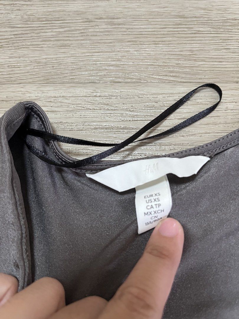 H&M Grey V-Neck Cap Sleeve Bodysuit (Category: Others Tops) located in Taytay. Submitted by j1123 (Listing ID 1454409105, Image 3). Description: - Grey H&M bodysuit - V-neck cut - Short cap sleeves - Stretchy material for comfort - Convenient snap closure at the bottom - Perfect basic piece, easy to style up or down zara mango cotton on stradivarius editors market edikted skims uniqlo.