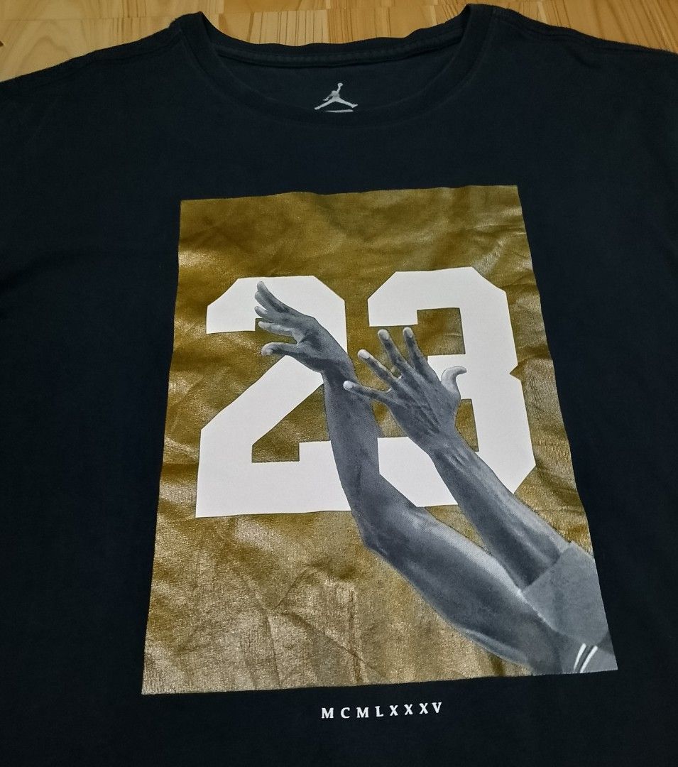 Jordan "23" Graphic T-Shirt (Category: Tshirts & Polo Shirts ) located in San Jose del Monte. Submitted by azetor (Listing ID 1454388260, Image 3). Description: - Black Jordan T-Shirt - Features Michael Jordan's hands and #23 graphic print - Gold background for the print - Size: Large (L) on tags - Material: 100% Cotton - Measurements - chest 19.5 - length 27 - excellent condition - color rate 10/10.