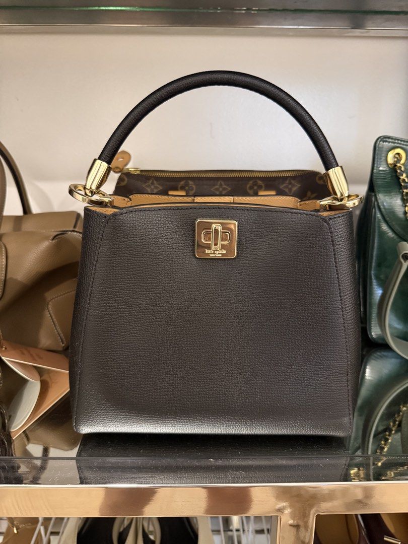 Kate Spade Black Leather Top Handle Bag (Category: Luxury Bags & Wallets) located in San Juan City. Submitted by dyclutter (Listing ID 1454411576, Image 1). Description: Kate Spade Small Phoebe Top Handle bag - Material: Black pebbled leather - Closure: Gold turn-lock - Handle: Curved top handle (with long strap) - Interior: Tan lining - Style: Structured, classic - Occasion: Everyday or special events RFS: decluttering Shipping must be shouldere