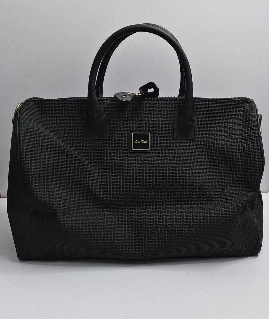 La Veé Black Woven Weekender Bag (Category: Briefcases) located in Baguio. Submitted by PreiLoveMaria (Listing ID 1454457031, Image 2). Description: La Veé Black Woven Weekender Bag Designed with a textured woven exterior, sleek black leather handles, and gold-tone hardware, it opens up to a vibrant yellow interior with multiple organizational pockets. Perfect for short trips, staycations, or as a carry-on ​Item Details: ​Brand: La Veé ​Dimension