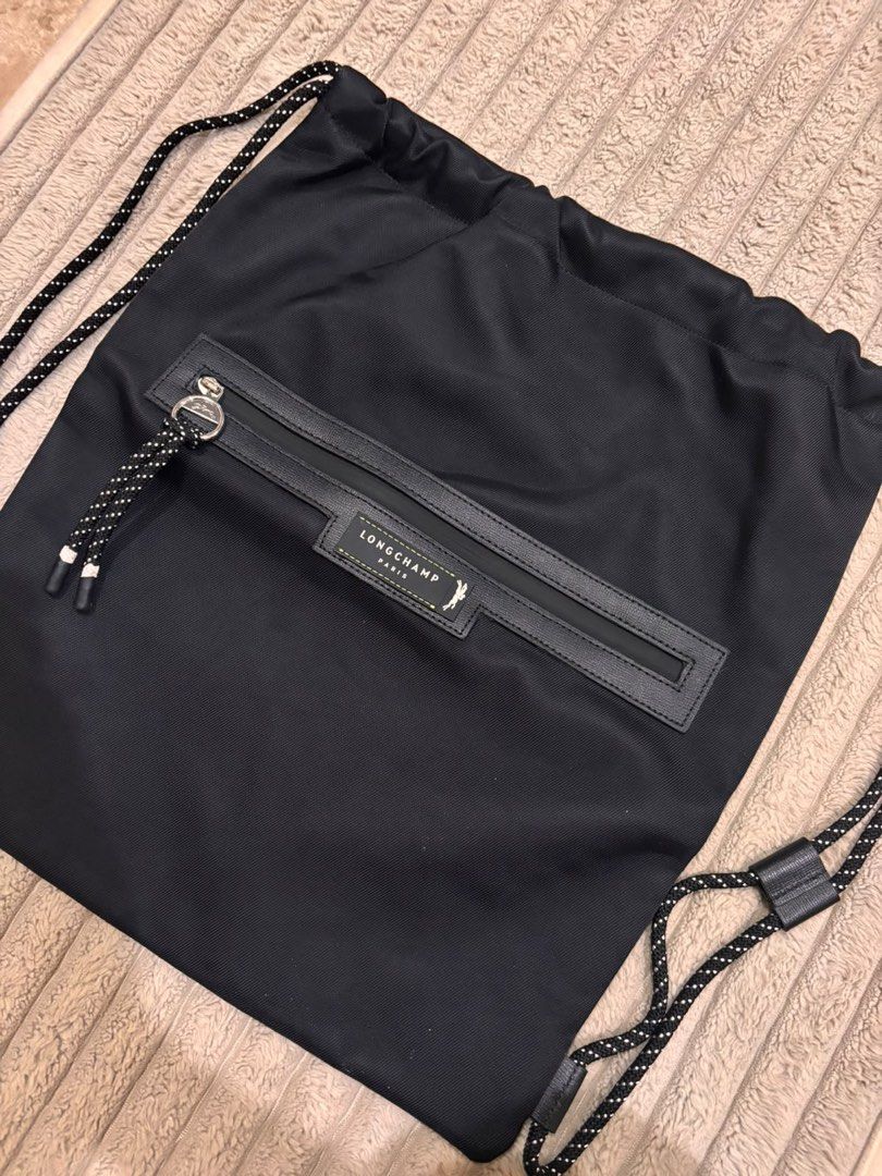 Longchamp Paris Black Nylon Drawstring Backpack (Category: Backpacks) located in Paranaque City. Submitted by mjclosetph17 (Listing ID 1454559398, Image 3). Description: 🎒 Longchamp Green District Medium Drawstring Backpack Brand New / Never Used ✨ 💚 Green | Lightweight fabric + leather details 📏 Size: 15”W × 17”H × 2”D ✔️ Never used, stored only ✔️ No visible dirt/stains ✔️ No holes, tears, rubs or flaws 🎁 Authenticity Disclosure: Received a