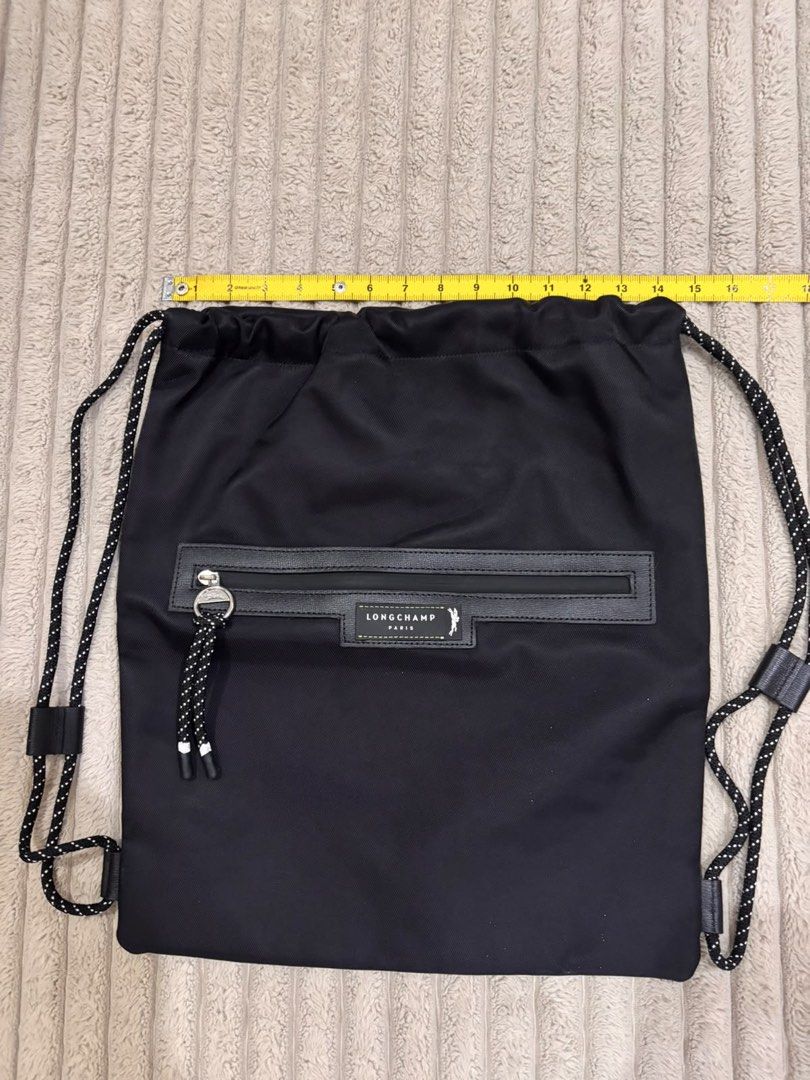 Longchamp Paris Black Nylon Drawstring Backpack (Category: Backpacks) located in Paranaque City. Submitted by mjclosetph17 (Listing ID 1454559398, Image 2). Description: 🎒 Longchamp Green District Medium Drawstring Backpack Brand New / Never Used ✨ 💚 Green | Lightweight fabric + leather details 📏 Size: 15”W × 17”H × 2”D ✔️ Never used, stored only ✔️ No visible dirt/stains ✔️ No holes, tears, rubs or flaws 🎁 Authenticity Disclosure: Received a
