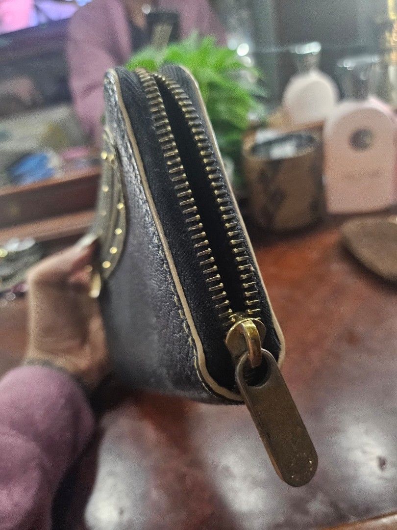 Authentic LV zio around wallet (Category: Luxury Bags & Wallets) located in Pinamalayan. Submitted by braveheartfiftyfive (Listing ID 1454429710, Image 3). Description: - On Sale fastbreak - Color: Black - Material: Leather - Closure: Zip-around - Hardware: Gold-tone - Interior: Multiple card slots and compartments for organization - Condition: Good, with some signs of wear.