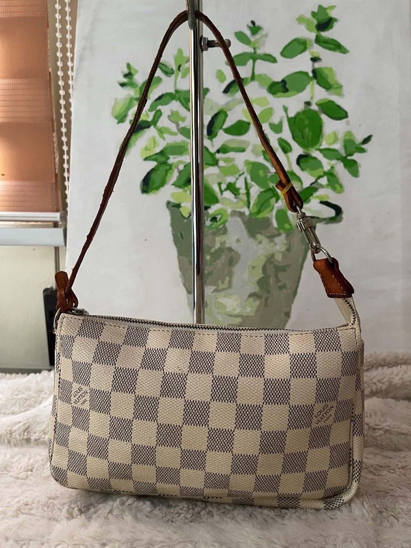 Louis Vuitton Damier Azur Pochette Bag (Category: Luxury Bags & Wallets) located in Naawan. Submitted by twilly.apparel2 (Listing ID 1454409567, Image 1). Description: - issue no code, crack ang leather sa handle Louis Vuitton Pochette - Damier Azur Canvas - Leather strap shows some signs of wear - Zipper functions smoothly - Interior is clean - Dimensions: Approx. 9.5" L x 4" H - Ideal for carrying essentials.