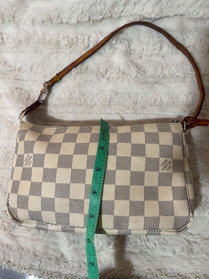 Louis Vuitton Damier Azur Pochette Bag (Category: Luxury Bags & Wallets) located in Naawan. Submitted by twilly.apparel2 (Listing ID 1454409567, Image 3). Description: - issue no code, crack ang leather sa handle Louis Vuitton Pochette - Damier Azur Canvas - Leather strap shows some signs of wear - Zipper functions smoothly - Interior is clean - Dimensions: Approx. 9.5" L x 4" H - Ideal for carrying essentials.