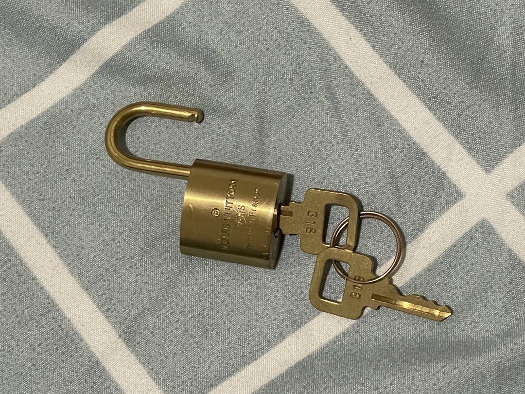 LV Lock Set (Category: Luxury Accessories) located in Las Pinas. Submitted by marqusasasas (Listing ID 1454469479, Image 1). Description: Selling a Louis Vuitton lock set in a classic gold-tone finish. Includes the padlock, matching keys, and attached key ring/chain as shown in the photos. * Brand: Louis Vuitton * Color: Gold tone * Condition: Lightly used * Includes: Lock, keys, and key ring/chain * Gender: Unisex * Great as a replacement lock/a