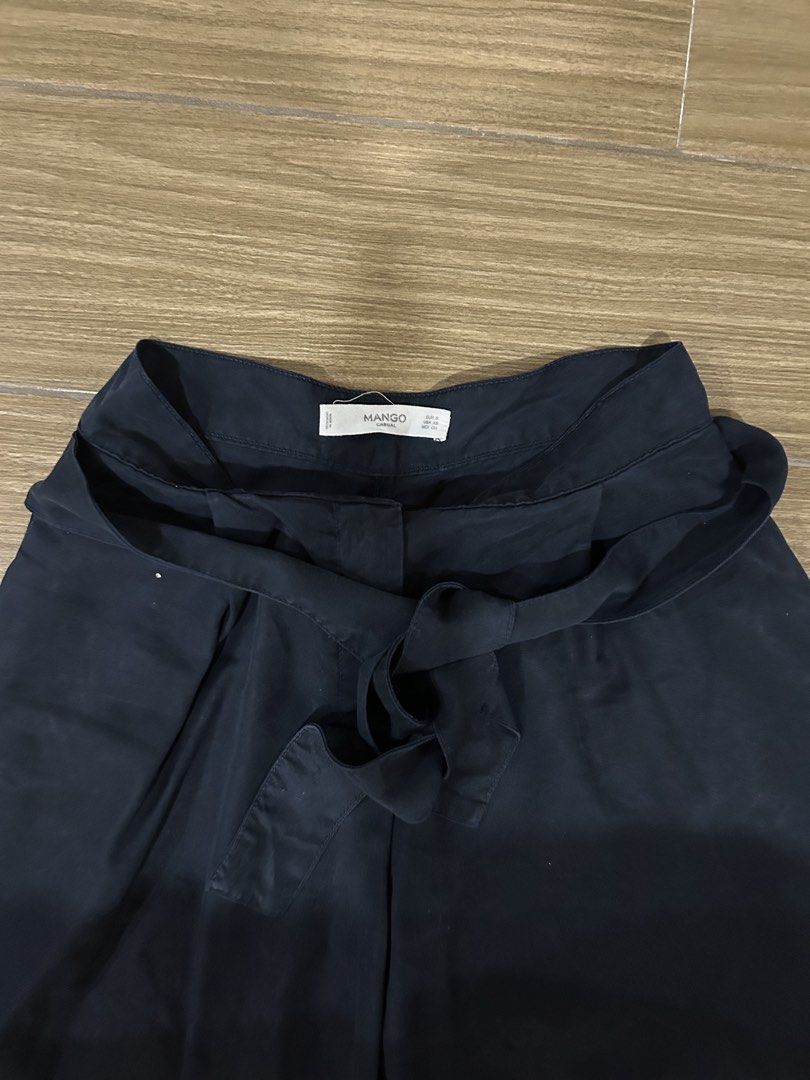 Mango Navy Blue Culottes with Ribbon Belt (Category: Shorts) located in San Juan City. Submitted by curatedbymae (Listing ID 1454397415, Image 2). Description: Item: Mango Navy Blue Culottes with Ribbon Belt - waistline: 26 in. approx - length (waist to bottom): 28 in. Size: XS Mode of payment: GCASH/MAYA Shipping: Grab/Lalamove/J&T (Buyer will shoulder shipping fees.).