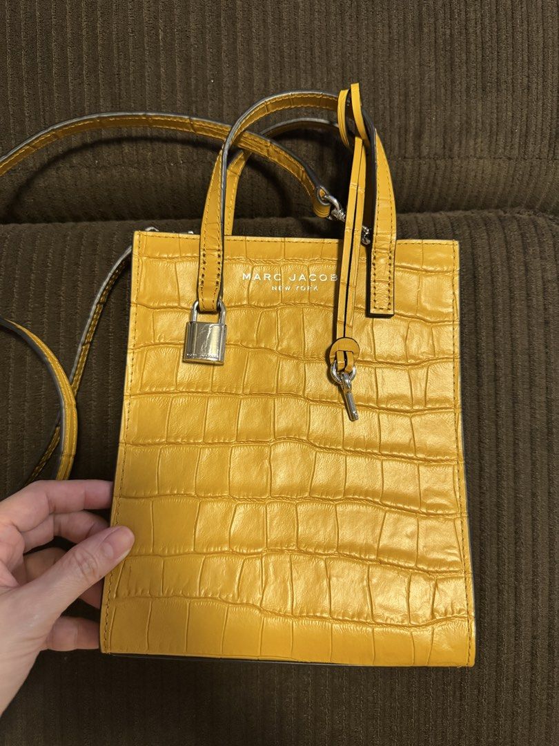 Marc Jacobs Yellow Croc Embossed Mini Tote Bag (Category: Luxury Bags & Wallets) located in Quezon City. Submitted by everyuniverse (Listing ID 1454418861, Image 2). Description: - Brand: Marc Jacobs - Color: Yellow - Material: Croc-embossed - Style: Mini Tote Bag - Features: Top handles, detachable crossbody strap, lock and key detail - Interior: Black - Size: Small and compact, ideal for essentials - Perfect for: Adding a pop of color to your o