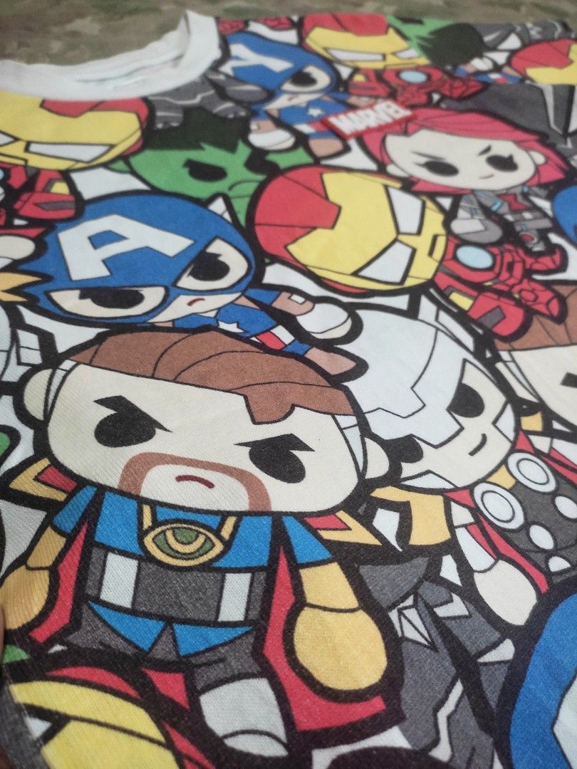 MARVEL x CHOCOOLATE tshirt (Category: Tshirts & Polo Shirts ) located in Abucay. Submitted by adaglai13 (Listing ID 1454407844, Image 2). Description: Brand & Details - Collaboration: :CHOCOOLATE × Marvel ​ - Size: XXS (fits like extra small/teen size, 160/80A) ​ - Material: Soft knit cotton blend, casual lightweight fit ​ - Style: All-over print tee Design & Features - Full print of chibi/cute-style Marvel heroes: Captain America, Iron Man, Hulk