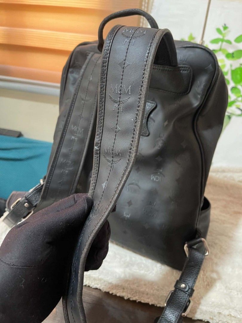 MCM Monogram Backpack Black with flaws (Category: Luxury Bags & Wallets) located in Naawan. Submitted by twilly.apparel2 (Listing ID 1454382883, Image 3). Description: - issue may labas pipe, crack leather Authentic MCM backpack in black - Features iconic all-over monogram print - Includes a convenient front zip pocket - Side pockets for extra storage - Metal plate has minor scratches - Still a functional and fashionable bag.