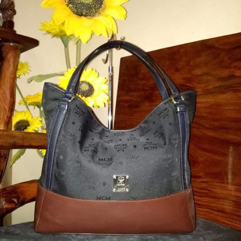 MCM Monogram Canvas & Leather Hobo Shoulder Bag (Category: Luxury Bags & Wallets) located in Cagayan de Oro. Submitted by mmmdshop (Listing ID 1454548237, Image 1). Description: - Authentic MCM Hobo Bag - Classic MCM monogram print on canvas - Dark blue leather trim - Rich brown leather base - Gold-tone hardware with MCM logo plate - Spacious interior - Ideal for everyday use.
