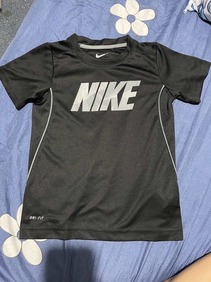 Nike Dri-Fit T-Shirt Black (Category: Babies & Kids Fashion) located in Manila. Submitted by hi_abbd (Listing ID 1454559920, Image 1). Description: - Black Nike Dri-Fit T-shirt - Features a large Nike logo on the front - Side panels with a mesh-like texture for breathability - Ideal for sports activities or casual everyday wear - Measurements: Length 49cm, Width 38cm No when worn.