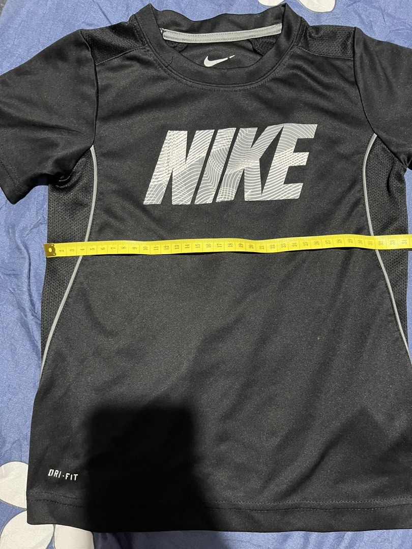 Nike Dri-Fit T-Shirt Black (Category: Babies & Kids Fashion) located in Manila. Submitted by hi_abbd (Listing ID 1454559920, Image 3). Description: - Black Nike Dri-Fit T-shirt - Features a large Nike logo on the front - Side panels with a mesh-like texture for breathability - Ideal for sports activities or casual everyday wear - Measurements: Length 49cm, Width 38cm No when worn.