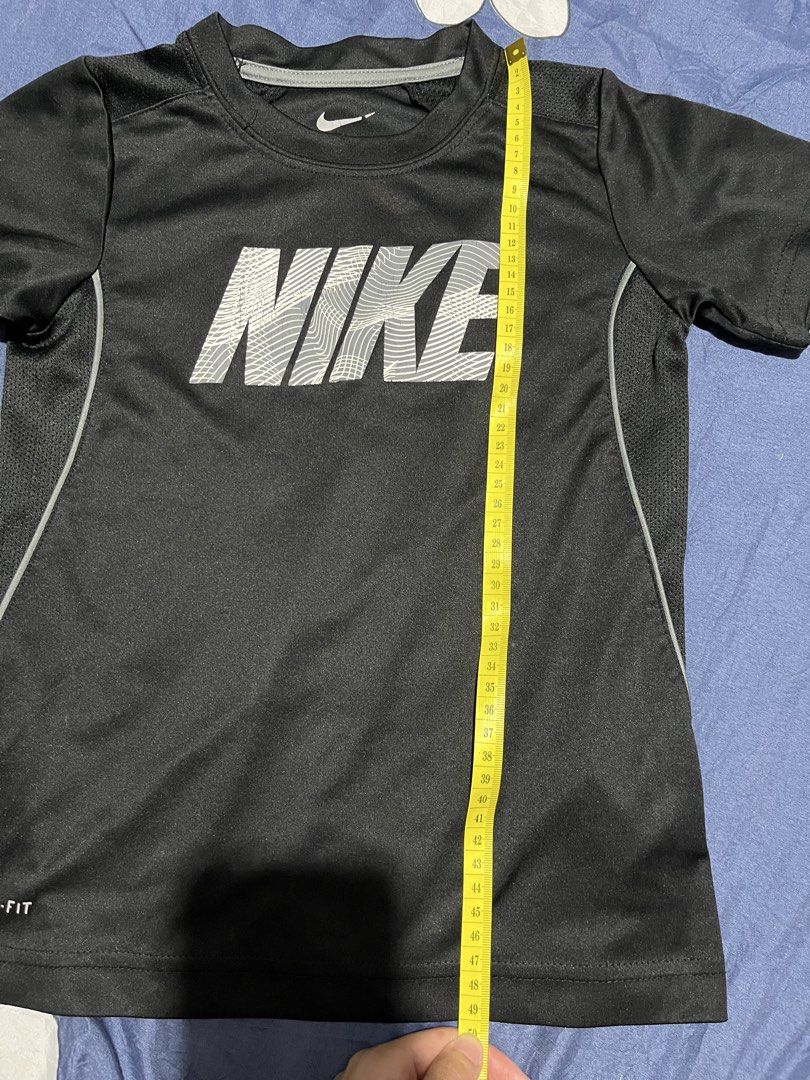 Nike Dri-Fit T-Shirt Black (Category: Babies & Kids Fashion) located in Manila. Submitted by hi_abbd (Listing ID 1454559920, Image 2). Description: - Black Nike Dri-Fit T-shirt - Features a large Nike logo on the front - Side panels with a mesh-like texture for breathability - Ideal for sports activities or casual everyday wear - Measurements: Length 49cm, Width 38cm No when worn.
