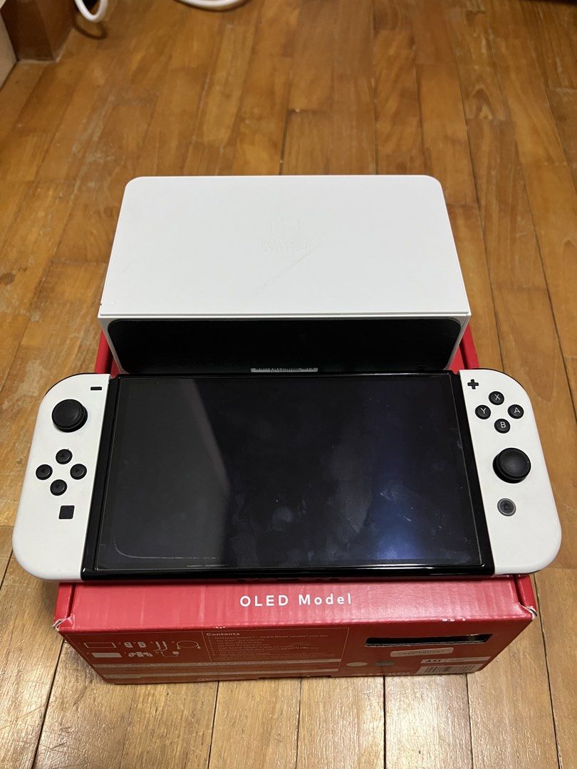 Nintendo Oled (Category: Nintendo) located in Singapore. Submitted by adventurerjk (Listing ID 1454369607, Image 1). Description: Got this switch for 2 year plus. Hardly use Comes with full box, case and screen protector ***NO GAMES INCLUDED***.