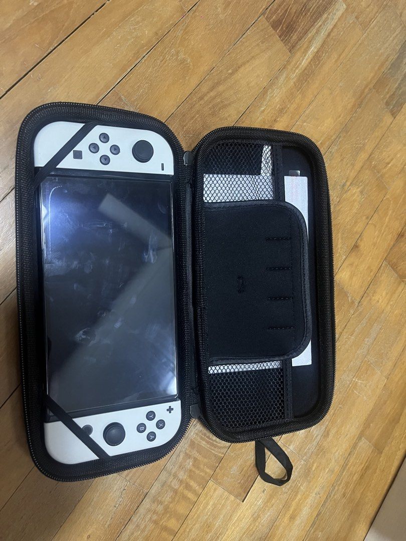 Nintendo Oled (Category: Nintendo) located in Singapore. Submitted by adventurerjk (Listing ID 1454369607, Image 3). Description: Got this switch for 2 year plus. Hardly use Comes with full box, case and screen protector ***NO GAMES INCLUDED***.