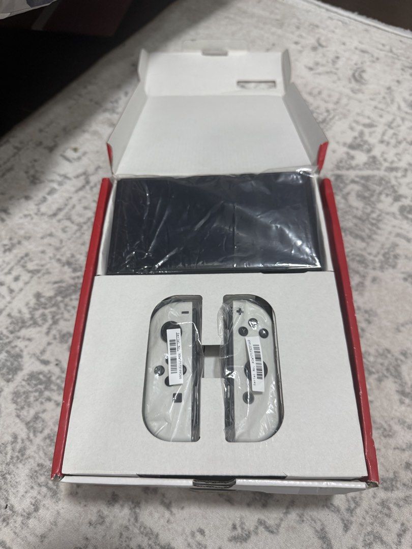 Nitendo Switch OLED (Category: Nintendo) located in Singapore. Submitted by alyshanazrie (Listing ID 1454528613, Image 3). Description: Selling my Nitendo Switch OLED cos i barely play it. Everything is in good working condition except that theres a little bit of paint splatter on the charging dock as you can see in the pic doesn’t affect anything tho just call it abstract BAHA. -full set with cables and joycons everything in the box - comes with