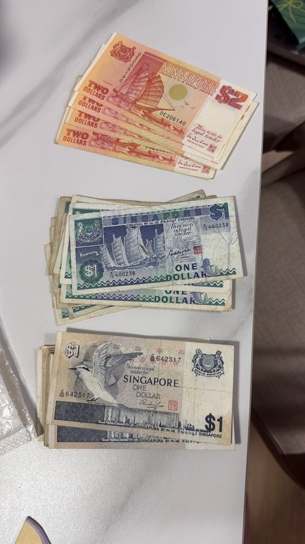 Old notes (Category: Currency) located in Singapore. Submitted by darrylphan10059 (Listing ID 1454530957, Image 1). Description: Set of 1 and 2 dollar, dm with best price Current Available: 5 pieces $2 boat 13 pieces $1 boat 22 pieces $1 bird.