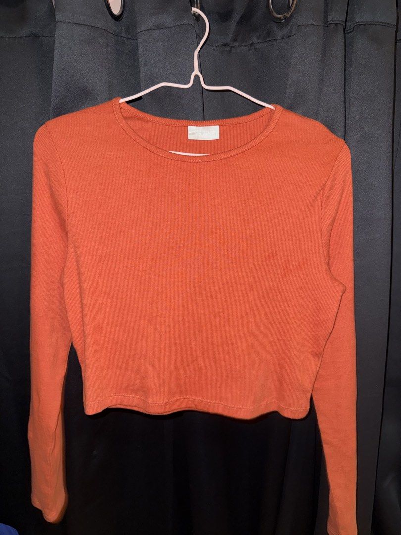 Orange Ribbed Cropped Long Sleeve Top (Category: Longsleeves) located in Quezon City. Submitted by lexix (Listing ID 1454486132, Image 1). Description: - Orange ribbed cropped long sleeve top - Soft and comfortable material - Classic round neckline - Versatile for layering or wearing on its own - Easily pairs with jeans or skirts.