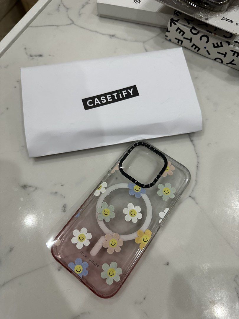 Original Casetify Iphone 15pro cases (Category: Cases & Sleeves) located in Quezon City. Submitted by reginapakaiguecristobal (Listing ID 1454497297, Image 1). Description: - Original Casetify case - Designed for iPhone 15 Pro - Features a charming smiley flower pattern - Clear case with a subtle pink hue - High-quality Casetify protection - Selling for 500 each 2300 for all.