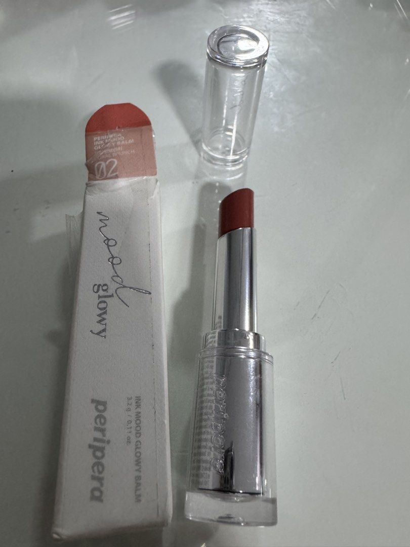 Peripera Ink Mood Glowy Balm 02 Cherry Brunch (Category: Makeup) located in Manila. Submitted by decluterthings888 (Listing ID 1454485820, Image 1). Description: - Peripera Ink Mood Glowy Balm - Shade: 02 Cherry Brunch - Type: Hydrating lip balm - Finish: Glossy - Packaging: Sleek silver tube with clear cap - Includes original box - Ideal for a natural, hydrated lip look.