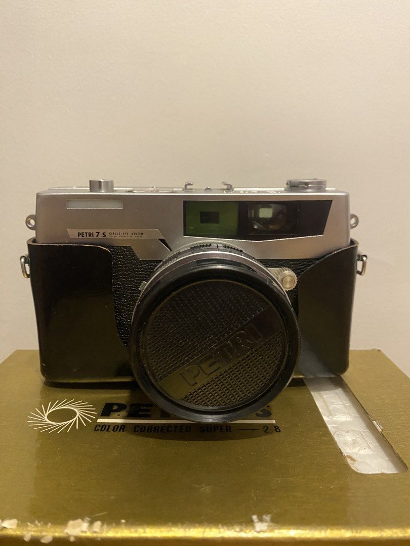 Petri 7S Color Corrected Super 2.8 Camera with Box (Category: Cameras) located in Taguig. Submitted by cosmickindle (Listing ID 1454487732, Image 2). Description: - Vintage Petri 7S film camera - Color Corrected Super 2.8 lens - Includes original box (shows wear but intact) - Includes lens cap and leather case. - Classic film camera, ideal for collectors or film shooters - Features leatherette body and silver top - Clean and all parts working. - 