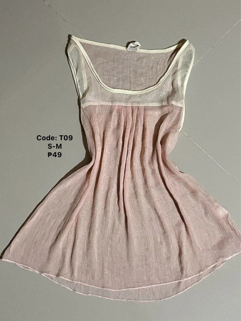 Pink Sheer Sleeveless Top (Category: Sleeveless) located in Iloilo. Submitted by geybrieeeel (Listing ID 1454439515, Image 1). Description: - Light pink sheer sleeveless top - Cream trim on neckline and armholes - Fabric with a subtle shimmer - Bodice features gathered pleats - Versatile for layering or wearing alone - Size S-M.