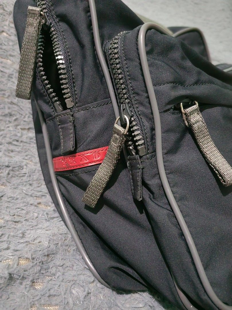 Prada Nylon Shoulder Bag Tote (Category: Luxury Bags & Wallets) located in Las Pinas. Submitted by huslerz (Listing ID 1454515483, Image 3). Description: - Prada Nylon Bag - Made in Italy - Two main compartments with zip closures - Front zip pocket - Adjustable shoulder straps - Ideal for everyday use - Article Number: 4VS049 - Material: 100% Polyester (Body), 100% Polyamide (Lining).