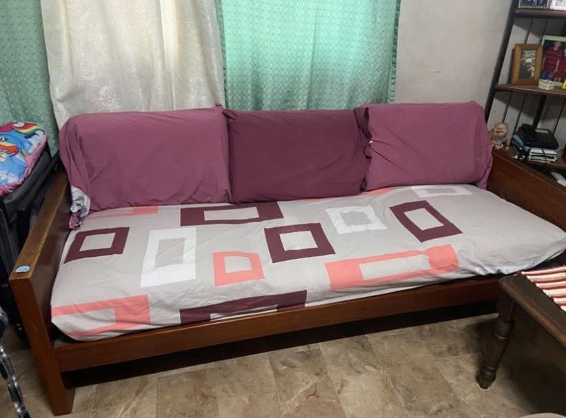 Pure Narra Sofa (Category: Sofas) located in Quezon City. Submitted by nathaliedychiao (Listing ID 1454557955, Image 3). Description: Solid wood sofa bed with cushions, pillows, and mattress topper. Features wooden backrest slats. Perfect for lounging or as an extra bed..