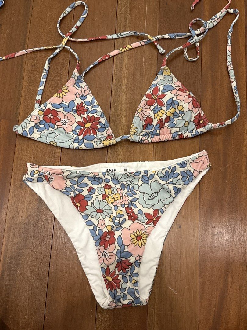 SASH Floral Print Triangle Bikini Set Size S (Category: Bikinis & Swimsuits) located in Iloilo. Submitted by closetcleanupzzzz (Listing ID 1454451378, Image 1). Description: No pads - Cute floral print bikini set from SASH - Features a triangle top with adjustable tie straps - Matching bikini bottoms - Print has pink, red, blue, and yellow flowers - Ideal for beach or pool outings.