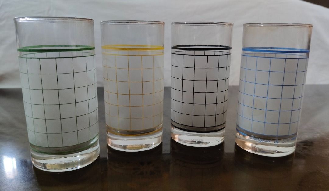 Xmas Discount!!! Set of 4 Vintage Grid Pattern Drinking Glasses Different Colors (Category: Dinnerware & Cutlery) located in Quezon City. Submitted by oddduck02 (Listing ID 1454531077, Image 3). Description: - Set of 4 Vintage Drinking glasses with grid pattern - Each glass has unique colored bands: green, yellow, black, and blue - Has a retro vibe - Approximate Size = 10 1/2cm tall - Reason for selling = Cleaning house .